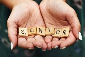 Senior on scrabble blocks in palm of hands